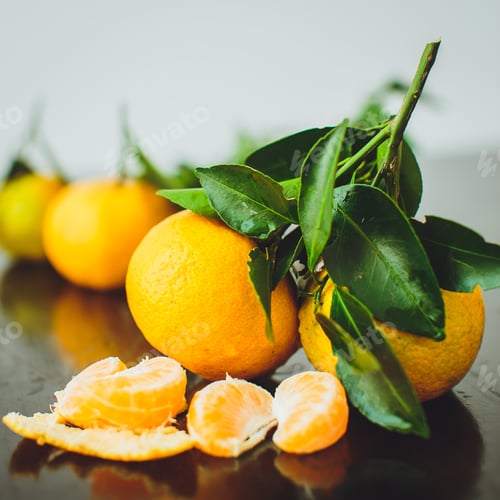 Preview: Tangerines with leaves on a wooden table.