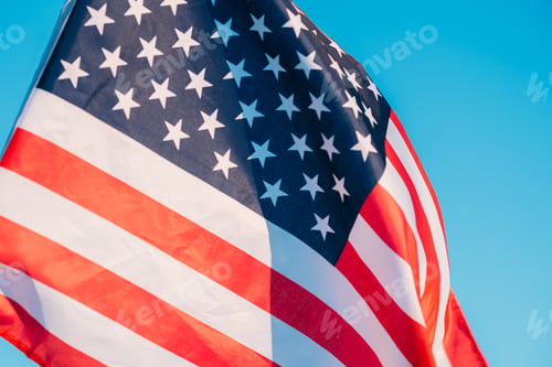 Preview: American flag in a blue sky, close up