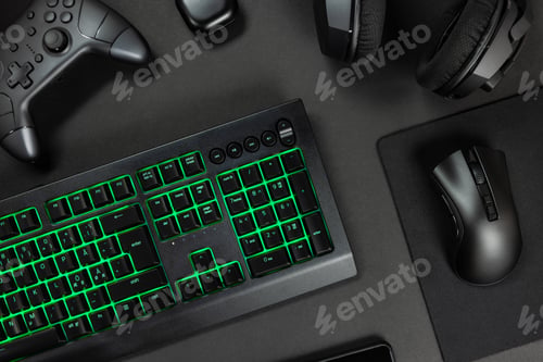 Preview: Green lit keyboard surrounded by various modern wireless gadgets