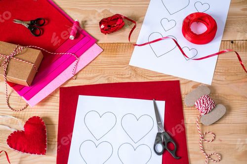 Preview: Valentine's day crafting, hearts and decorations mady of felt on wooden background