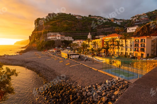 Preview: Orange sunset in Ponta do Sol, Madeira, aerial view of the beach in summer. Portugal