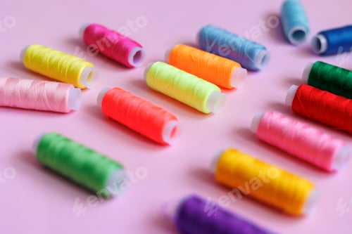 Preview: Bright colorful threads of neon colors lie on a pink background. Handmade work.