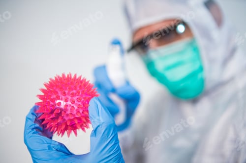 Preview: Doctor in protective suit use the sanitizer for Coronavirus red model. Covid-19