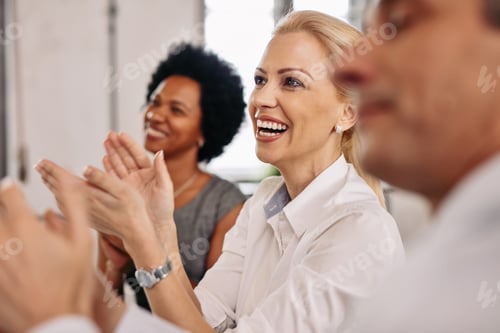Preview: Happy businesswoman and her colleagues clapping hands after the conference.