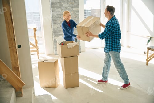 Preview: Joyful man giving cardboard box to smiling woman