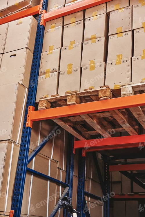 Preview: Stack of cardboard boxes on wooden pallet in distribution warehouse