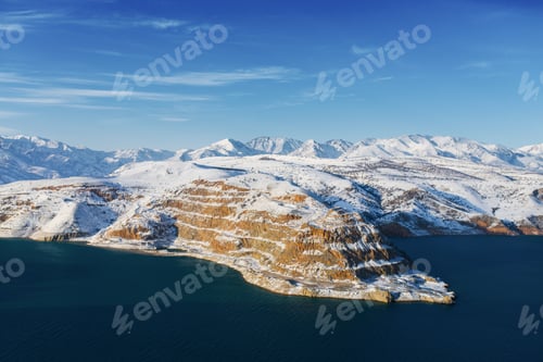 Preview: Amazing winter landscape of Charvak reservoir with blue water in Uzbekistan