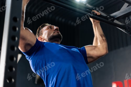 Preview: Caucasian sportsman slowly lift up weight machine barbell in stadium.