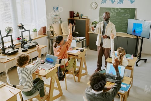 Preview: Teacher Guiding Students in Classroom With Computers