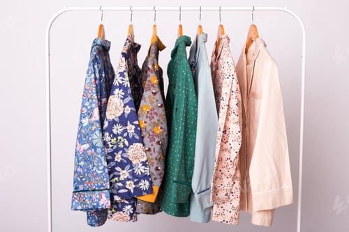 Preview: Clothing retails concept. Ladies pajamas on hangers in clothes store. Pajama in shop. Advertise