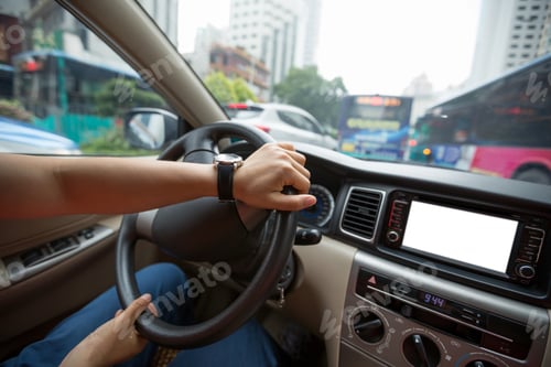 Preview: People hands holding steering wheel while driving car on city road