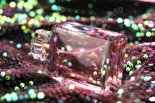 Preview: Luxury perfume in bottle on fabric with colorful sequins, closeup