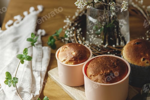 Preview: Baked fresh easter traditional bread on rustic wooden table with flowers