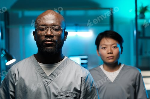 Preview: Two young intercultural laboratory workers looking at camera