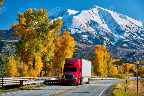 Preview: Red truck on highway in Colorado at autumn