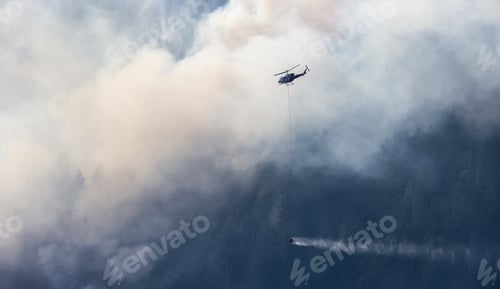Preview: Wildfire Service Helicopter flying over BC Forest Fire and Smoke on the mountain near Hope
