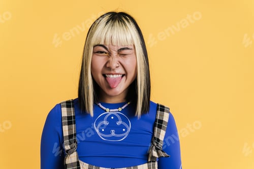 Preview: Asian girl with piercing showing her tongue and winking