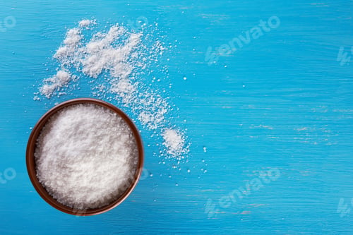 Preview: Clay brown bowl with salt on blue background