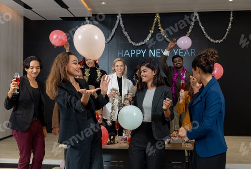 Preview: Business men and women hold balloon with multiethnic enjoy to dance in new year party with balloon