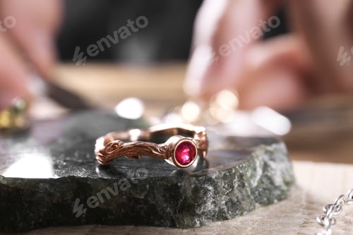 Preview: Ruby ring and blurred jeweler on background