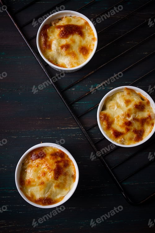 Preview: Julienne with mushrooms and cheese, in white ceramic cups, homemade, top view, no people,