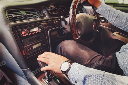 Preview: Men's hand on the steering wheel of the car