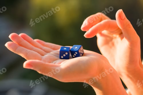 Preview: Dice 1 1 in the female hand, sunset background. Gambling devices.