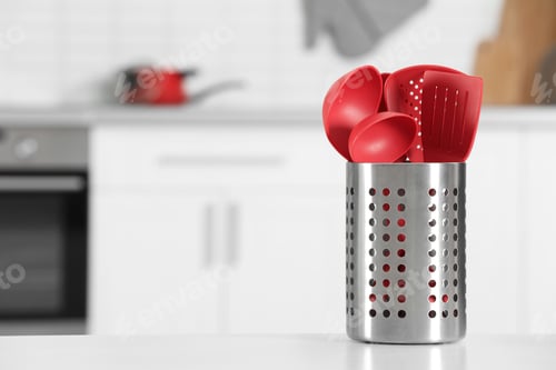 Preview: Holder with clean utensils on table in kitchen. Space for text