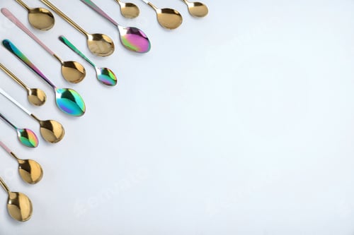 Preview: Set of new luxury spoons on white background, top view. Space for text