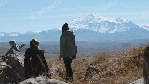 Preview: Carefree happy family hikers on mountain top on summer trip adventure. Creative. Family travel in