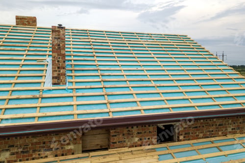 Preview: Aerial view of a wooden roof frame of brick house under construction.