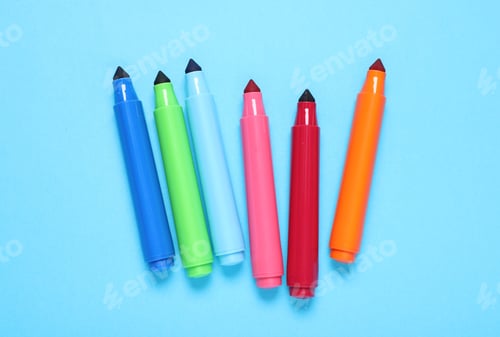 Preview: Many colorful markers on light blue background, flat lay