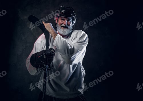 Preview: Joyful aged hockey player dressed in white sportswear