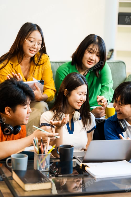 Preview: A group of young Asian college friends sitting on sofa at home,watching laptop,enjoying cheerful