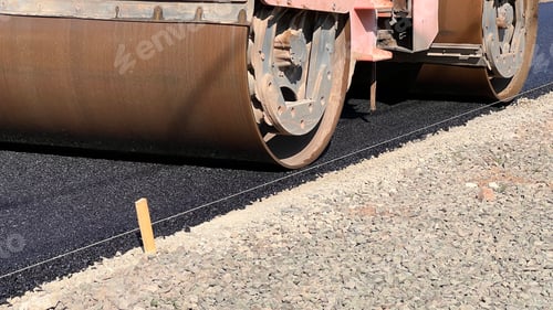 Preview: Asphalt paving roller. Road roller laying fresh asphalt, working on the new road construction site