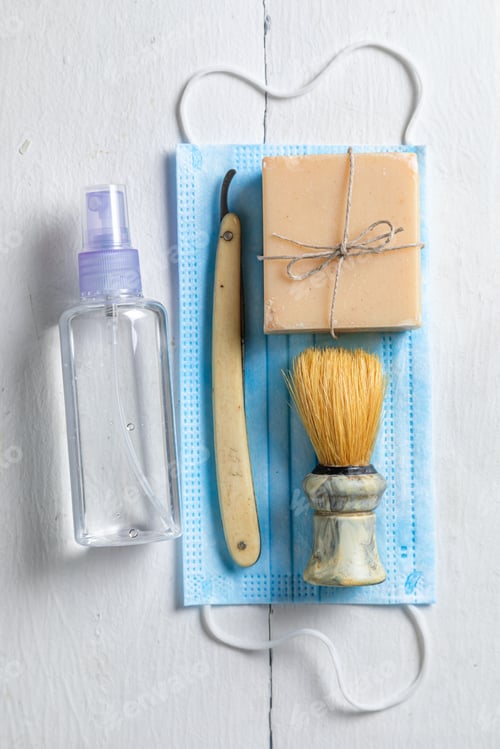 Preview: Antique barber equipment with razor, brush and mask in pandemic