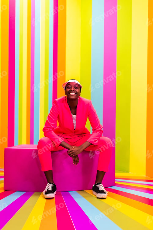Preview: Beautiful young woman dancing and having fun inside a rainbow box room