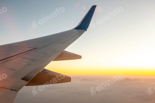 Preview: View from airplane on the aircraft white wing flying over desert landscape in sunny morning. Air