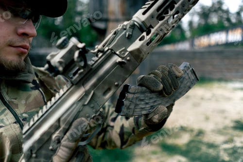 Preview: close-up military tactical strategy NATO rifle position for reloading a weapon training at