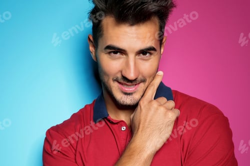 Preview: Young man with trendy hairstyle posing on color background