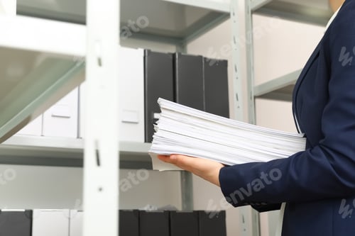 Preview: Female worker with documents in office, closeup