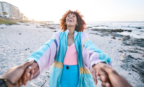 Preview: Love, happy and black woman holding hands with man, boyfriend or husband on the beach for travel, a