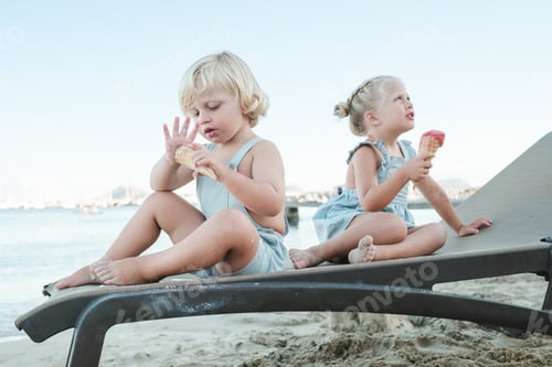 Preview: Children enjoying ice cream on sandy beach