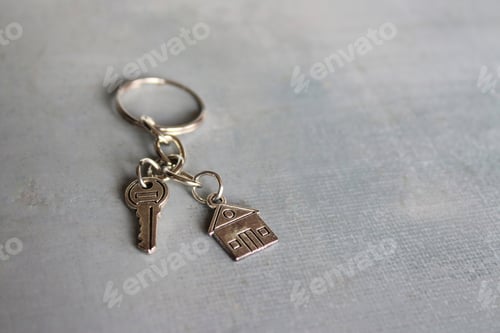 Preview: Closeup image of house shaped keychain and key with copy space