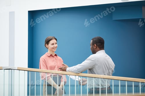 Preview: Smiling Young Woman Talking to Man at Work