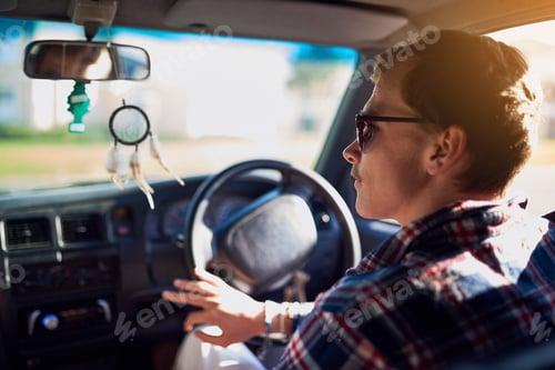 Preview: Know where youre going and get there. Rearview shot of a young man driving a car.