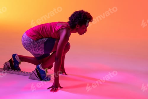 Preview: Image of african american female athlete preparing for run in neon orange and pink lighting