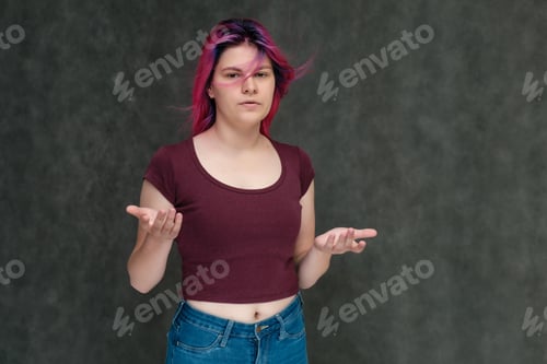 Preview: Portrait To The Waist Of A Young Pretty Teen Girl In A Burgundy T-Shirt And Jeans With Beautiful