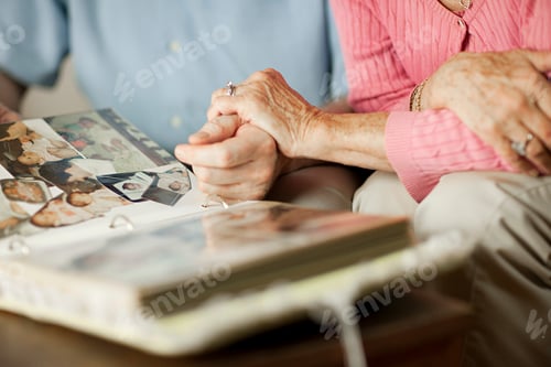 Preview: Two elderly people sharing memories with a photo album.