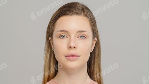 Preview: Beautiful young girl looks at the camera after professional makeup.